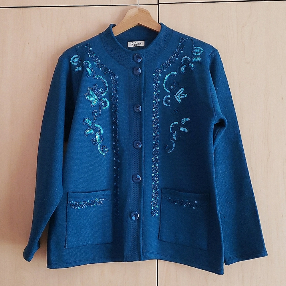 A beautiful blue button-down cardigan with blue sequence on the front